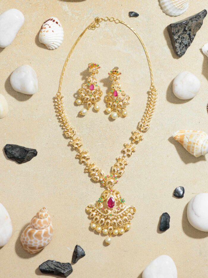 Heritage Harmony: Traditional Gold Necklace with Striking Red Stone Accent.