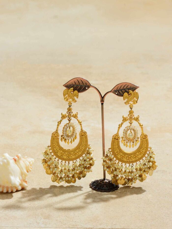 Lustrous gold earrings designed to mirror the fullness of a harvest moon, radiating warmth and timeless elegance