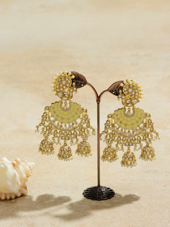 Exquisite gold earrings intricately designed to mimic the resplendent feathers of a peacock, radiating opulence and regality, making a statement of unparalleled elegance