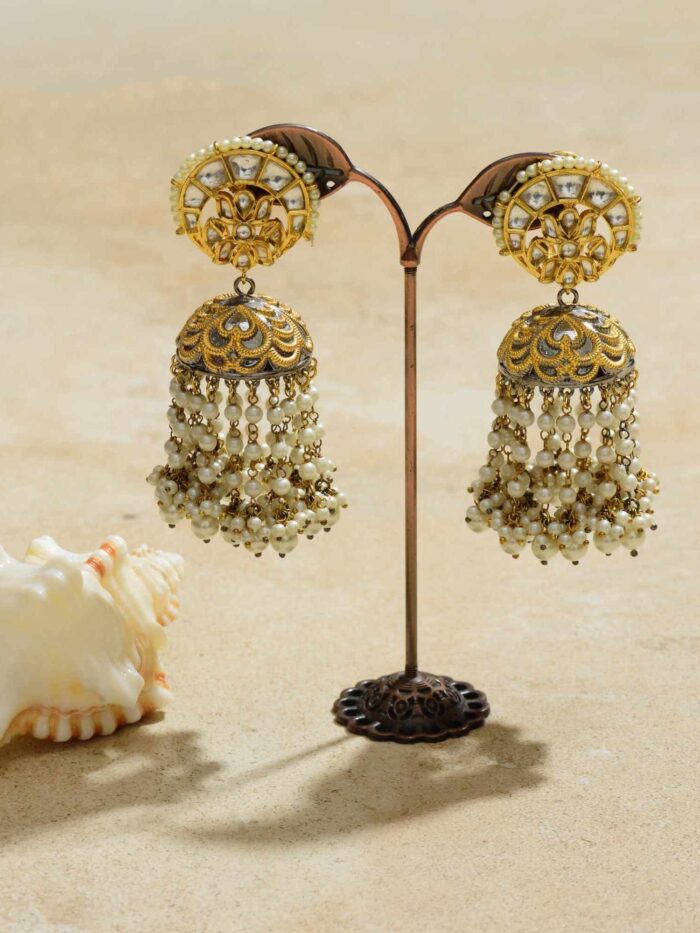 Adorn yourself with the opulent charm of Gilded Royalty Jhumkas, a regal blend of intricate design and luxurious elegance.