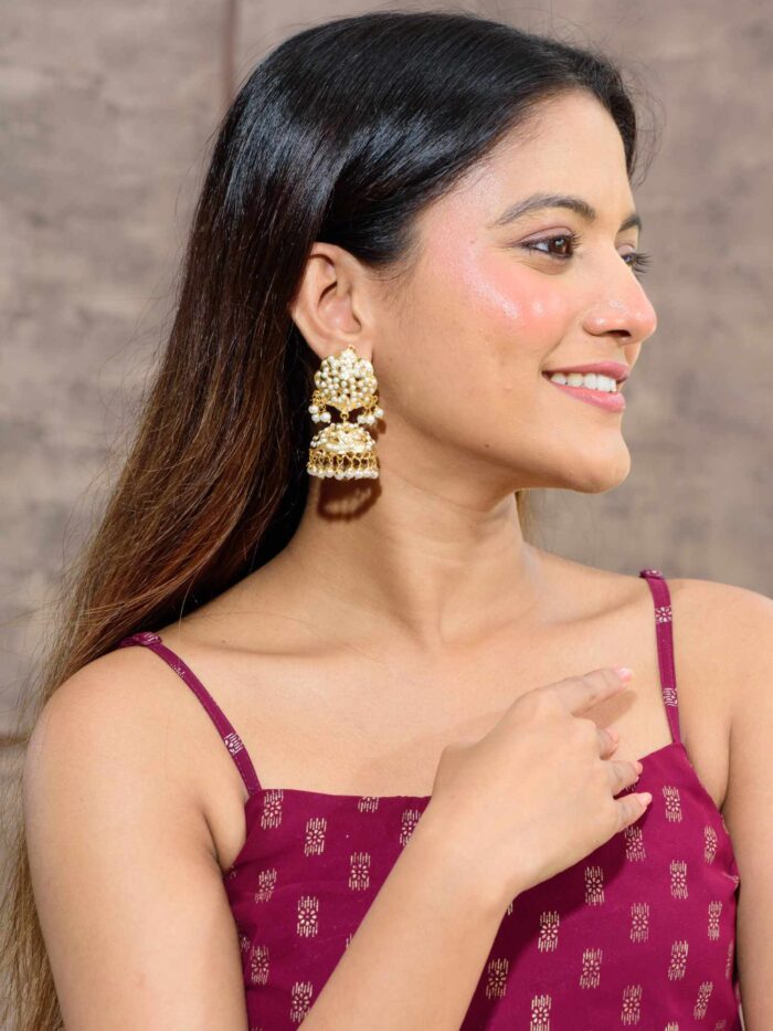 Gold jhumka earrings with sparkling champagne accents