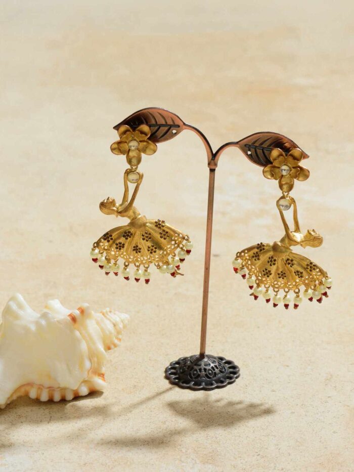 Shimmering earrings depicting a dancing diva in mid-motion