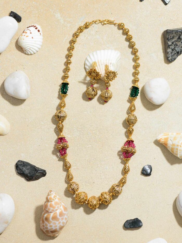 A Stunning Combination of Precious Gems and a Radiant Golden Orb Necklace.