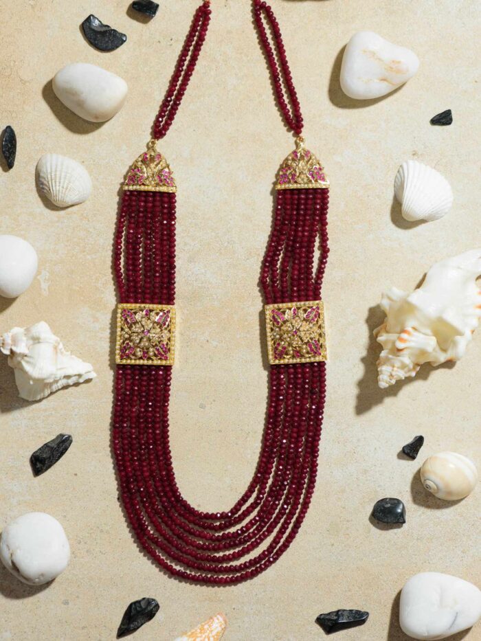 "Jadau Broach in Ruby Beads Necklace: A Striking Combination of Jadau Craftsmanship and Rich Ruby Beads.